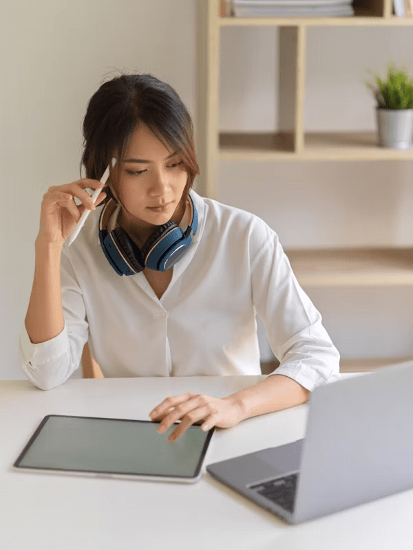 A young woman working with a contemplative expression