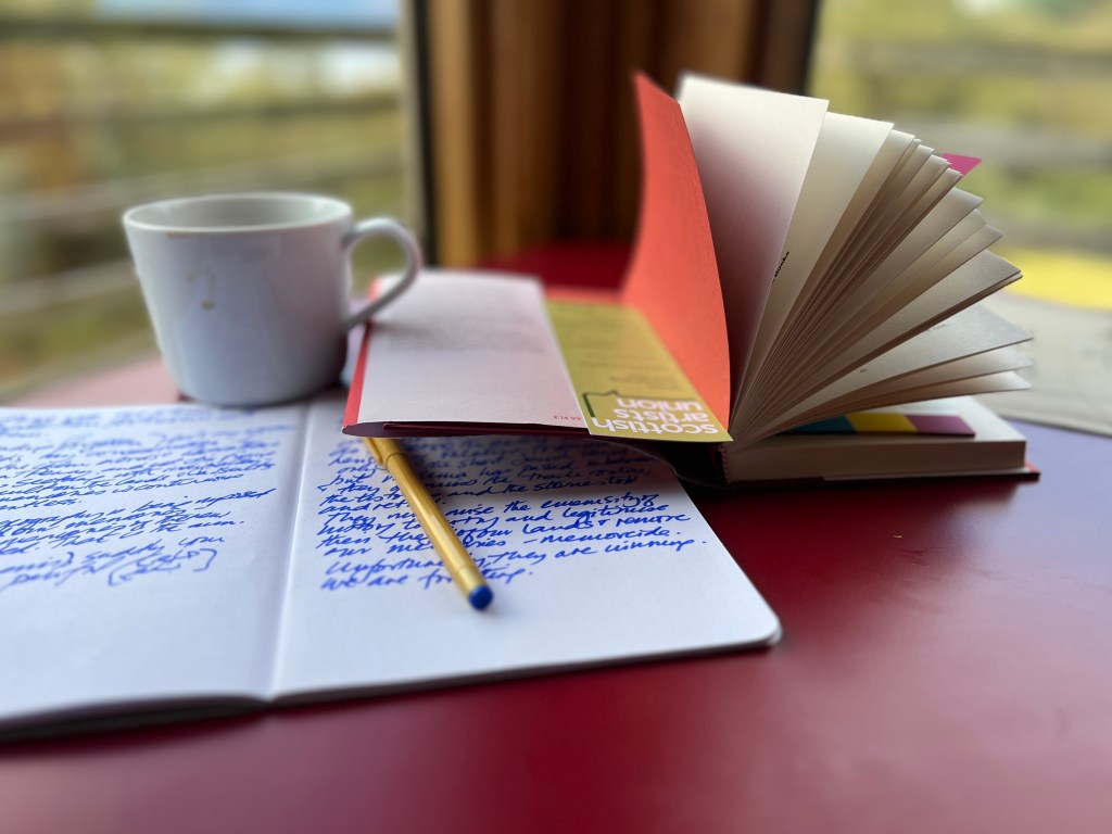 Desk with notebooks and coffee.