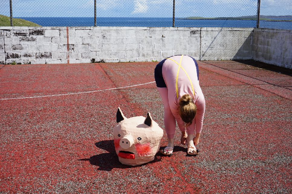 Getting ready for a re-enactment on a basketball court in a housing estate in Firth, Shetland, built especially for oil workers in the 1970s. Part of The Moving Energy Theatre tour, 2025.