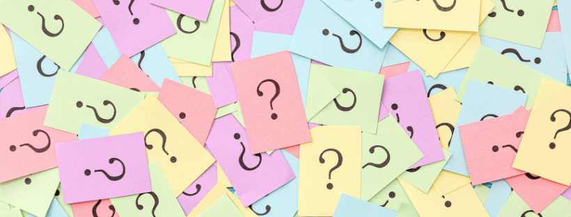 colourful papers with question marks as background