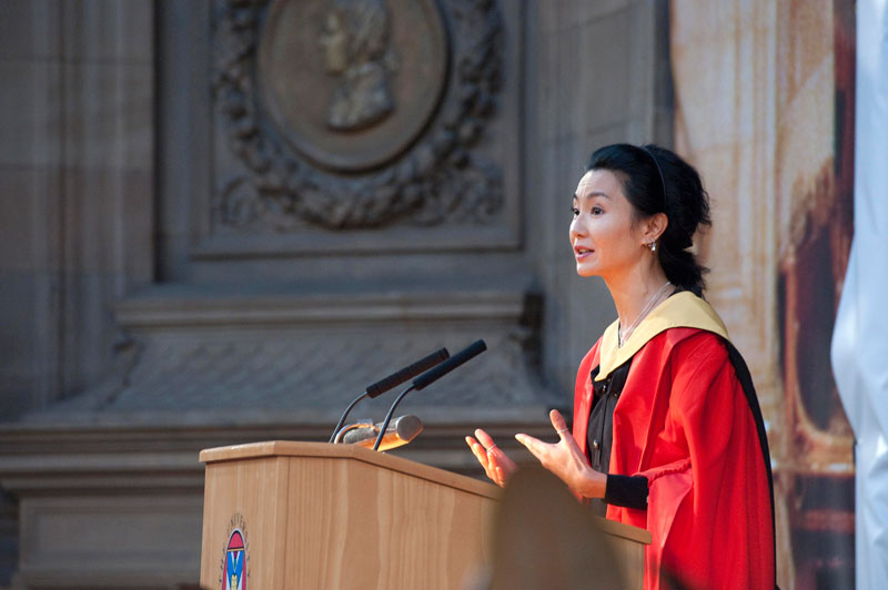 A female graduate speaking at a graduation ceremony.