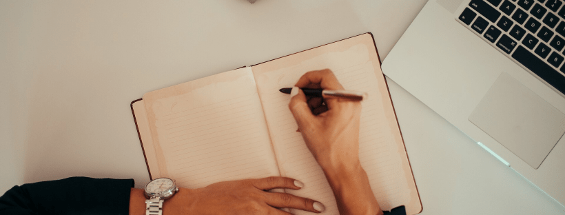 woman writing in a notebook